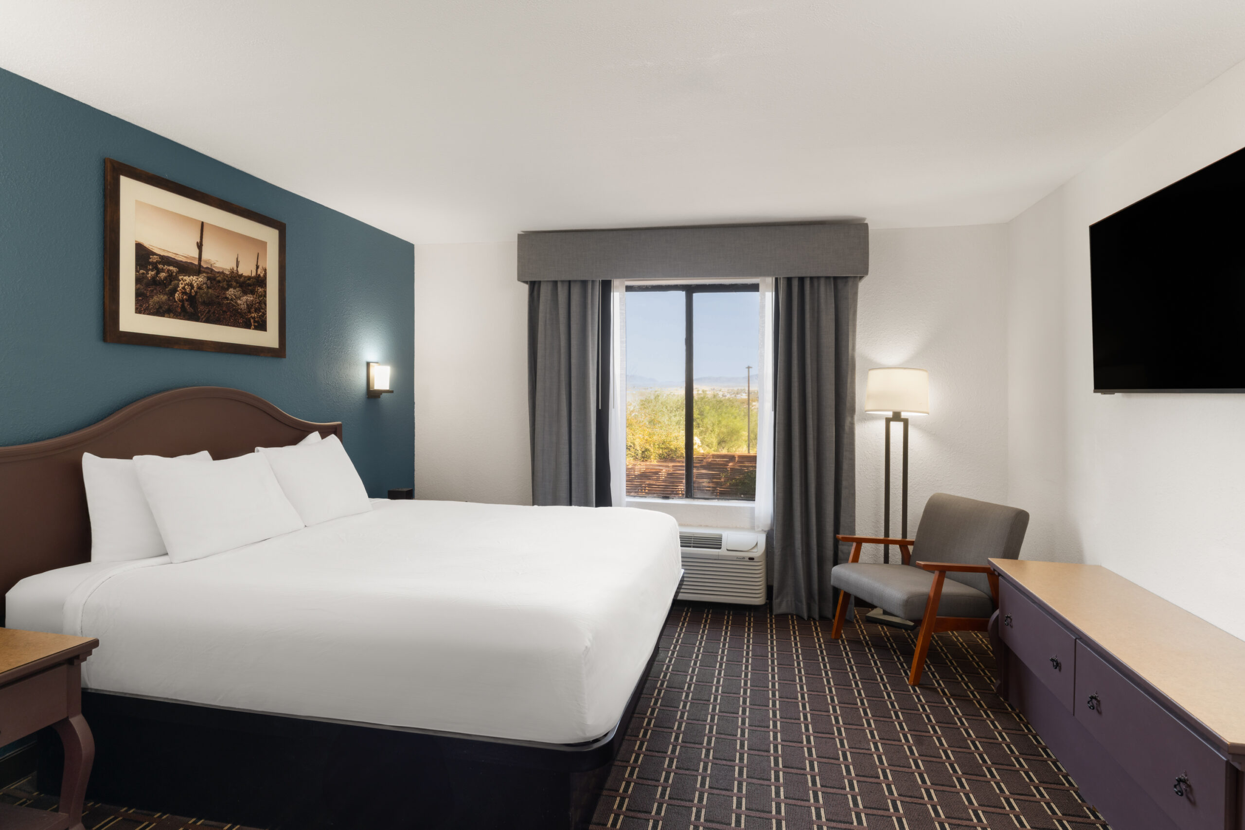 King guest room with workspace and TV