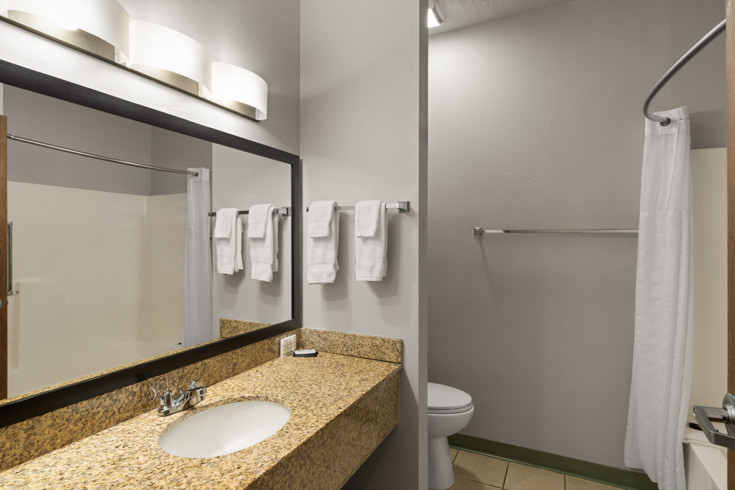 Guest bathroom with vanity and shower at Tombstone Grand Hotel