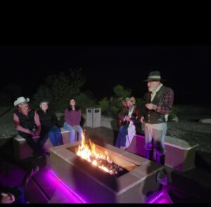 Guests gathered around the outdoor fire pit