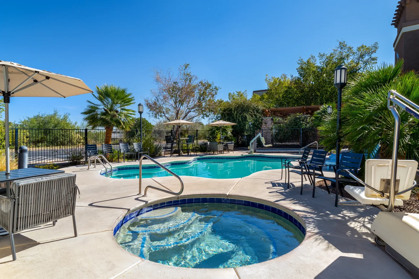 Outdoor hot tub beside the hotel swimming pool