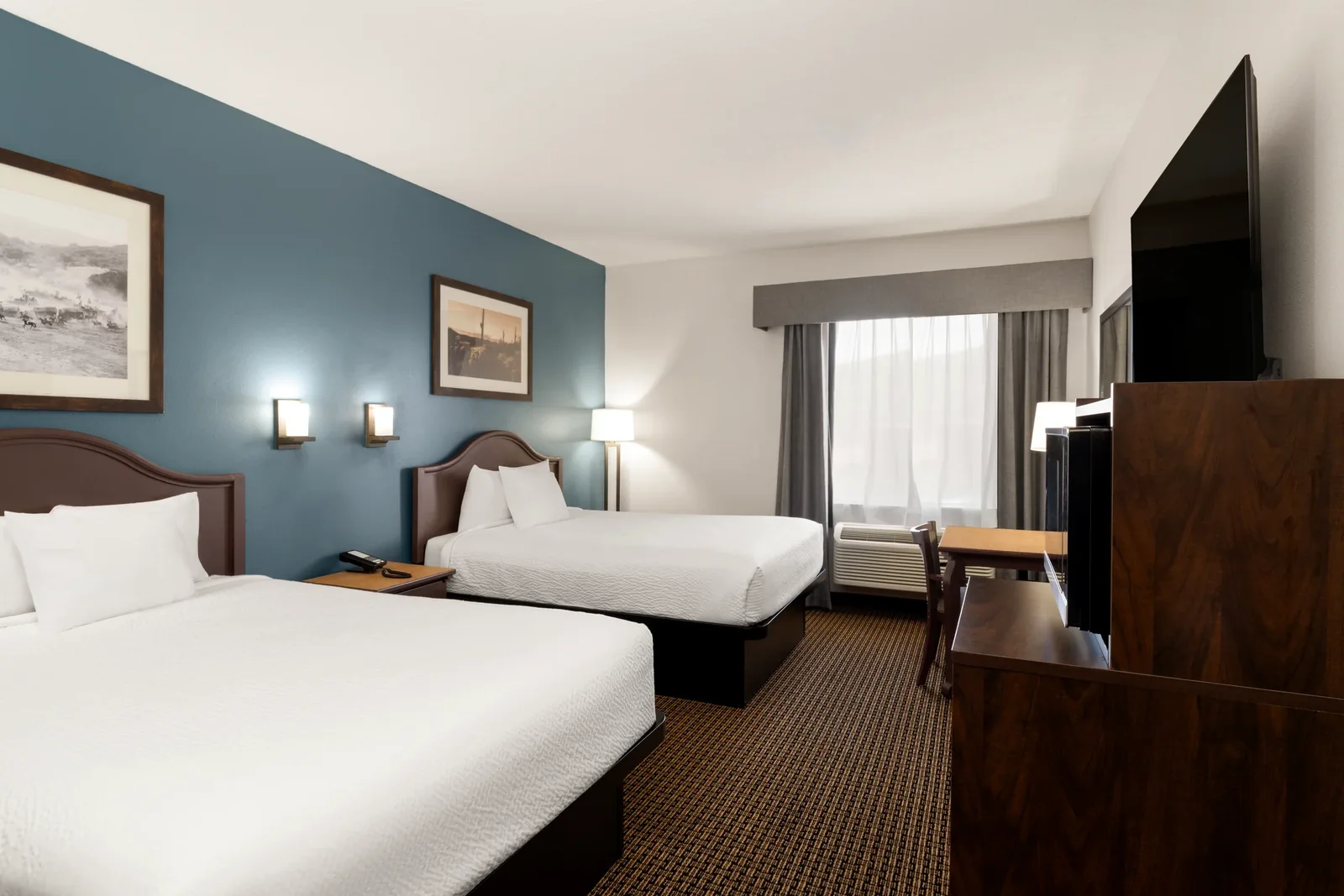 Two Queen guest room with desk, television and window